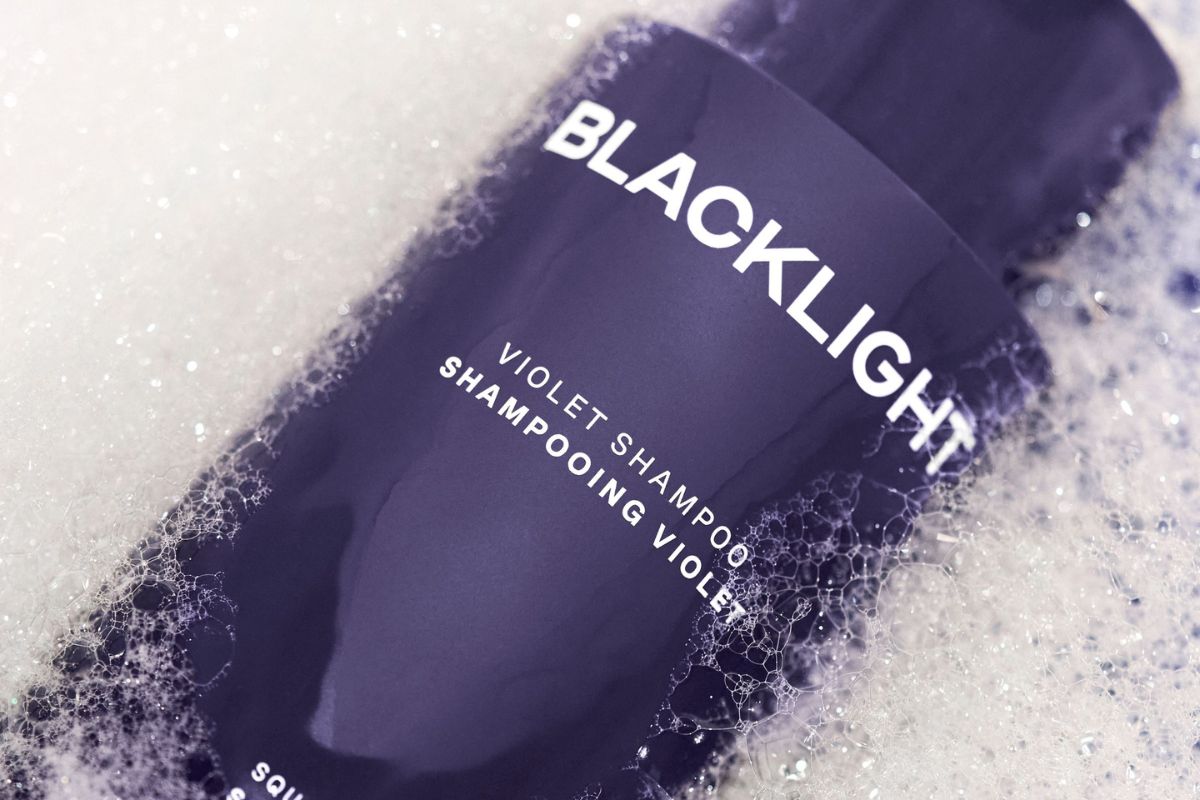 Image showing a bottle of Blacklight Violet Shampoo in bubbles