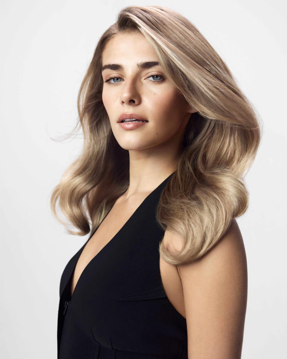 Blonde model with vibrant, brass-free blonde hair after using Blacklight Blonde Science blue toning products